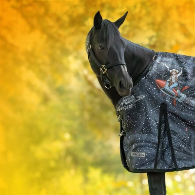 Fall Equine Catalog 2026. A black horse wearing a Jeffers Expression Cosmic Cowgirl blanket, set against a bright yellow background.
